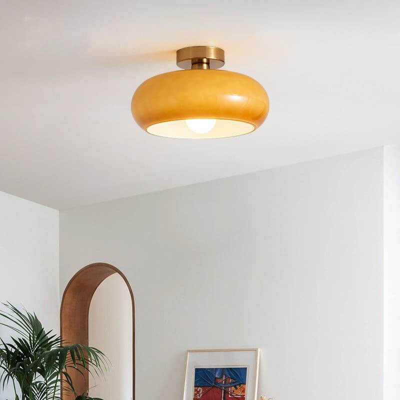 Orange round glass flush ceiling light with copper fitting