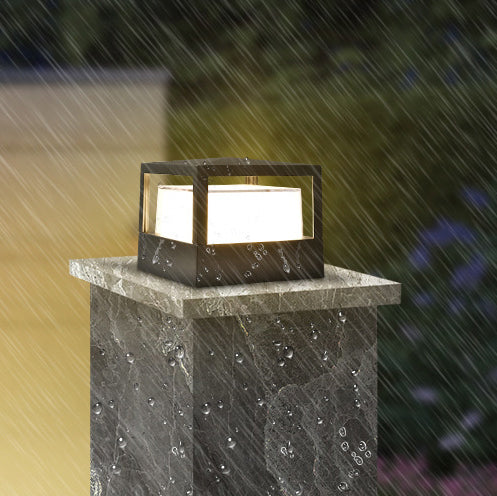 Black cylinder garden light on a lawn