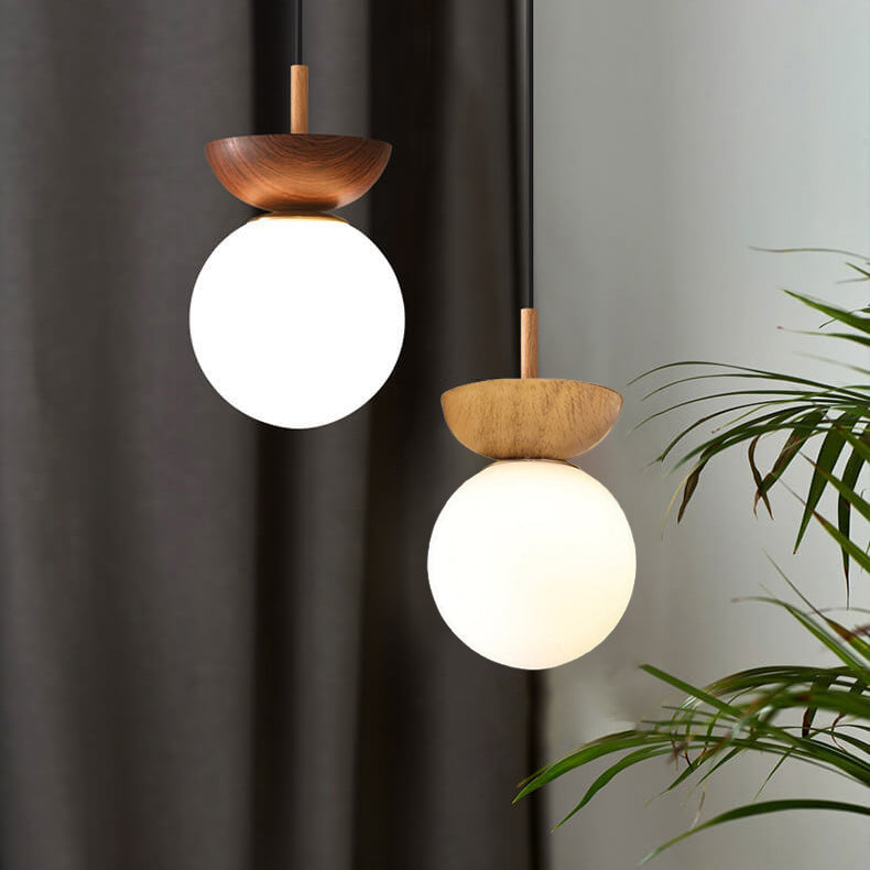 Glass orb light lit with filament bulb