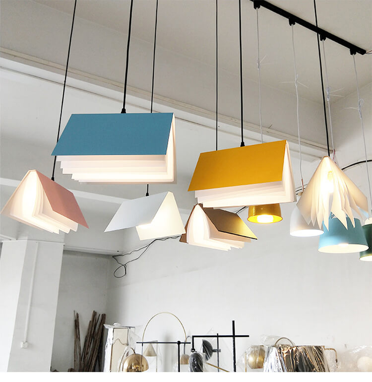 Flying book pendant light lit