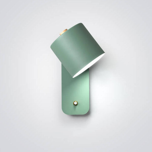 Green cylinder wall light on wall