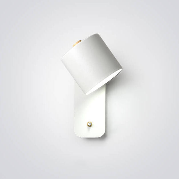 White cylinder wall light on wall