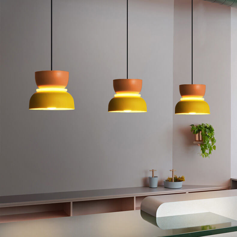 Macaron pendant lights grouped over a table