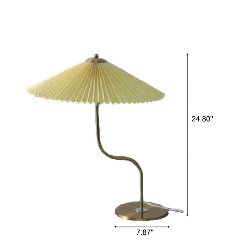 Pleated umbrella table lamp on a bedside table