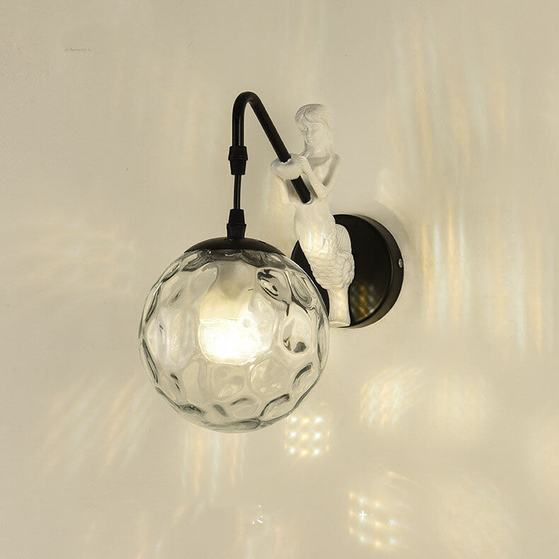 Black mermaid wall light with clear glass orb