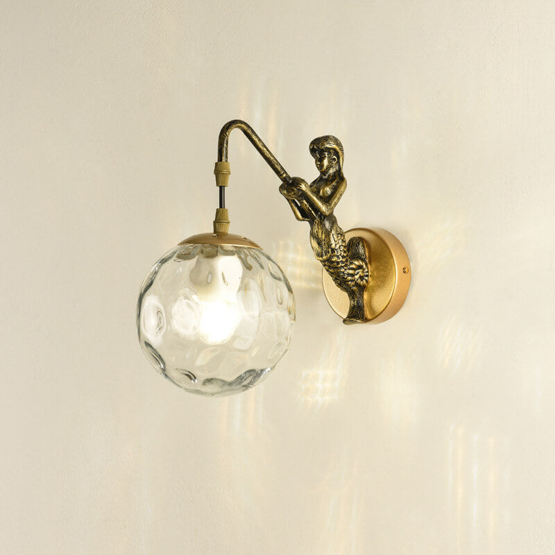 Gold mermaid wall light with clear glass orb