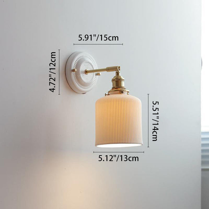 Ceramic wall light over a bedside table