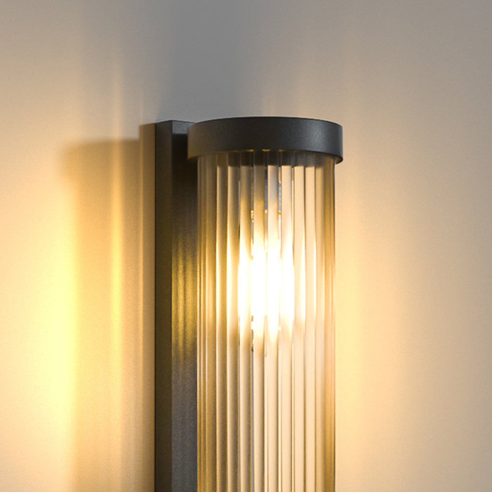 Cylinder outdoor wall lamp at dusk
