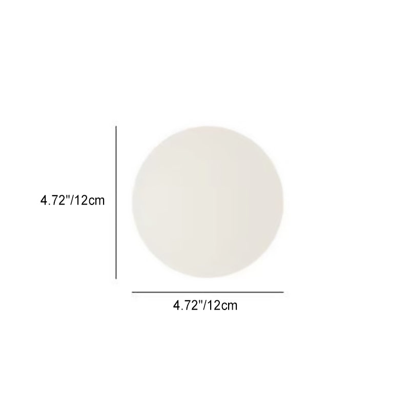Glass orb wall light in a bedroom