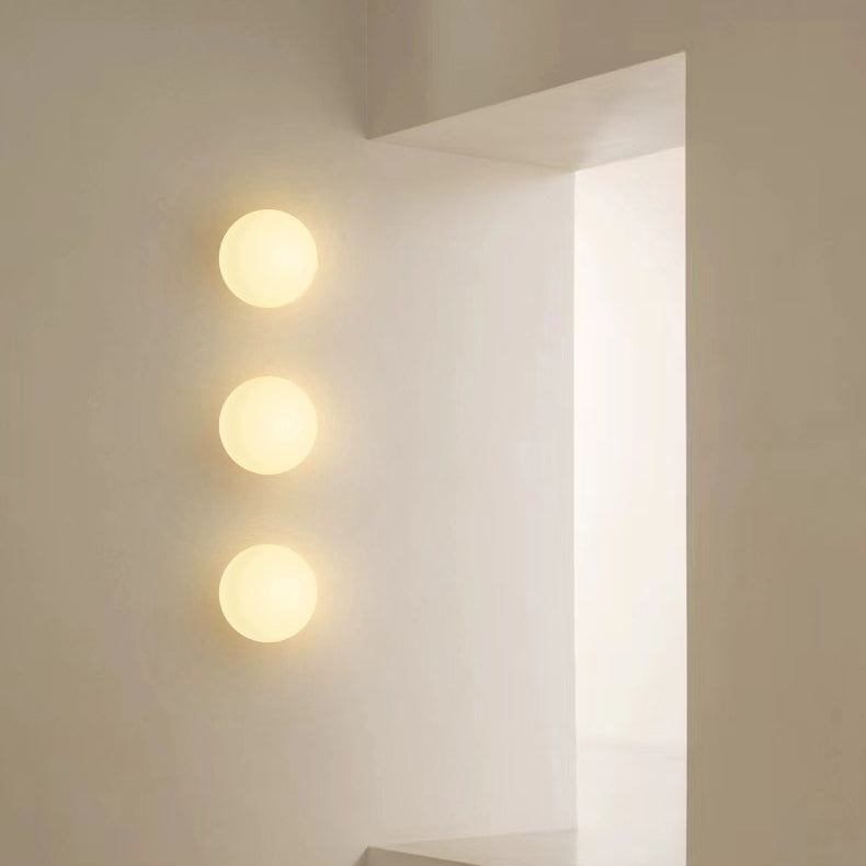 Small white glass orb wall light