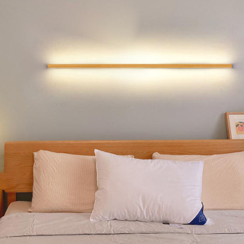 Wood strip LED wall light on wall