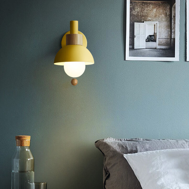 Macaron globe wall light on a bedroom wall