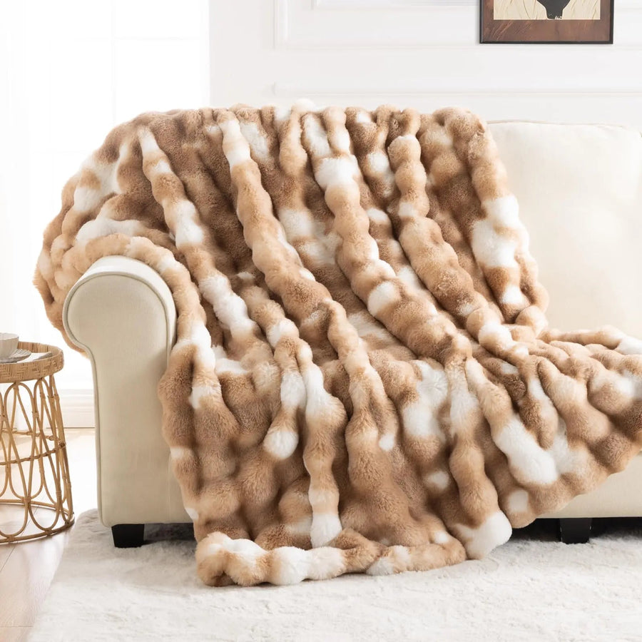 Tie dye faux fur blanket on a bed