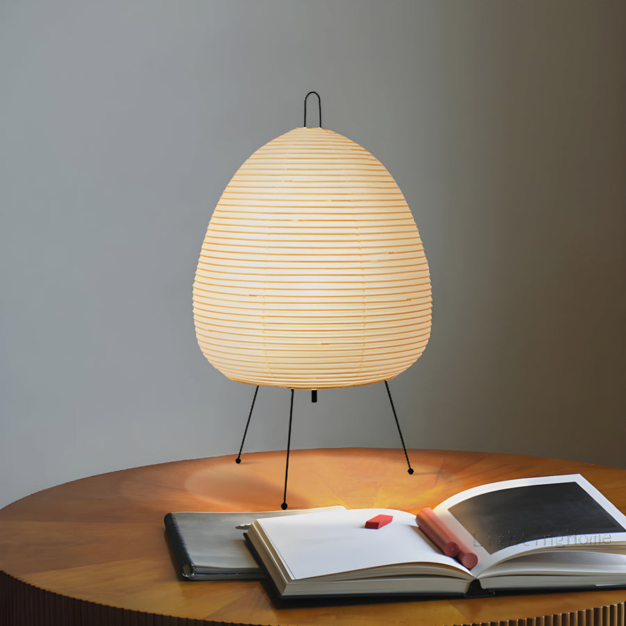 Rice paper table lamp glowing on a bedside table
