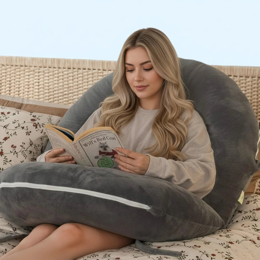 Modular U-shaped reading pillow on a bed