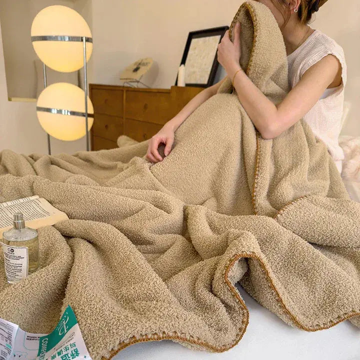 Thick lamb plush throw folded on a bed