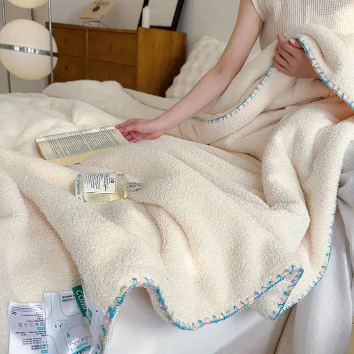 Plush bed throw draped over a sofa