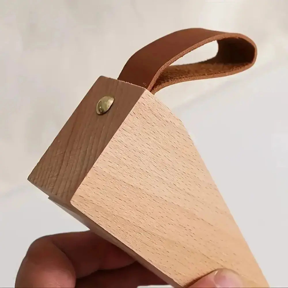 Wooden door stopper holding a door open