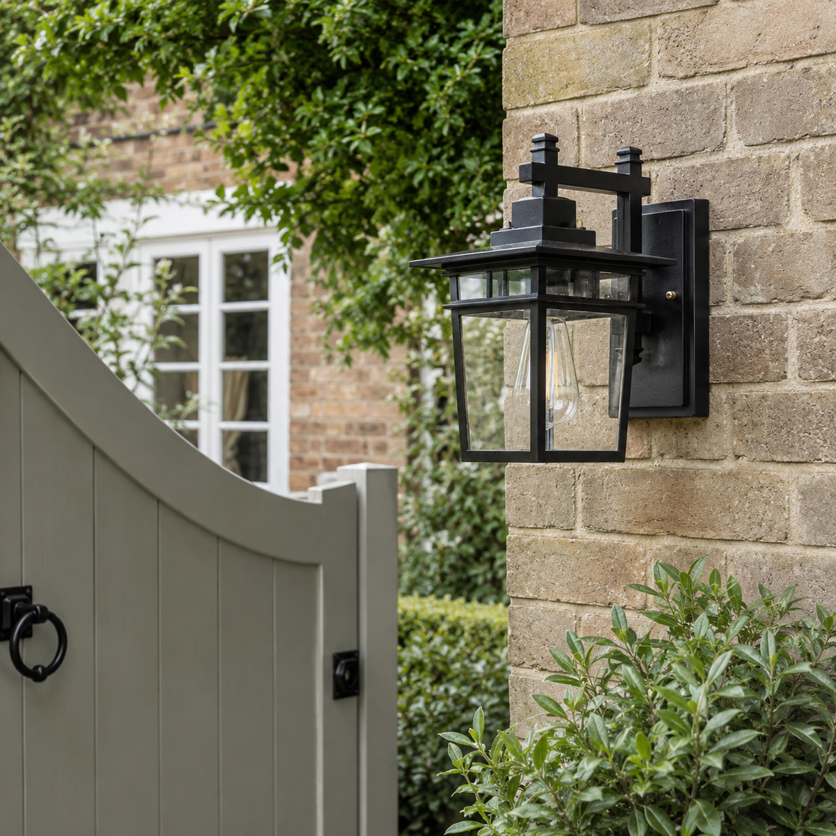 Coach lantern wall light on a garden wall