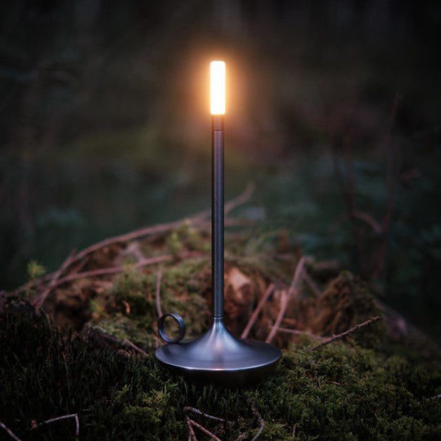 Black candlestick lamp lit