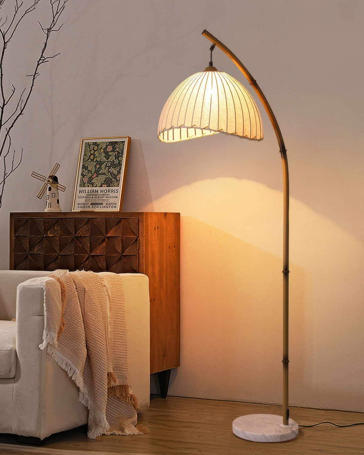 Bamboo-style floor lamp lit beside a sofa
