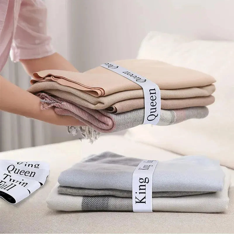 Labelled sheet bands in linen cupboard