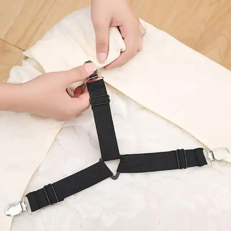 Crisscross bed sheet straps under a mattress