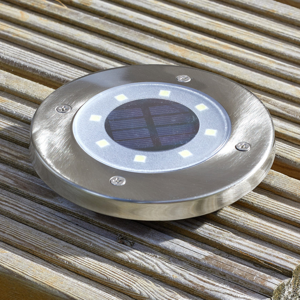Solar ground lights beside a patio
