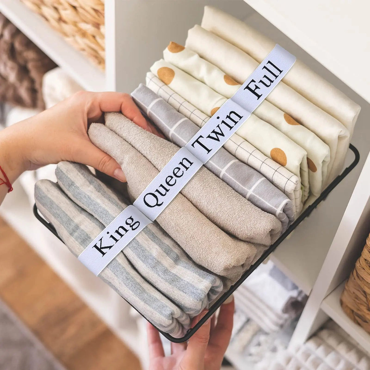 Elastic bed sheet organiser bands on folded linen