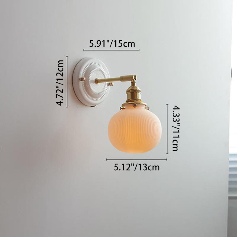 Ceramic wall light beside a mirror