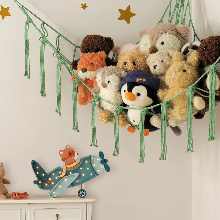 Green rope corner hammock filled with soft toys
