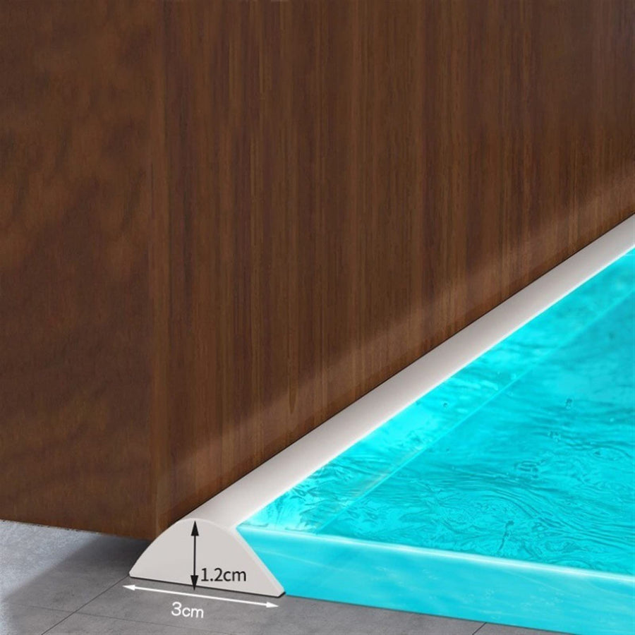Collapsible shower water barrier on a bathroom floor