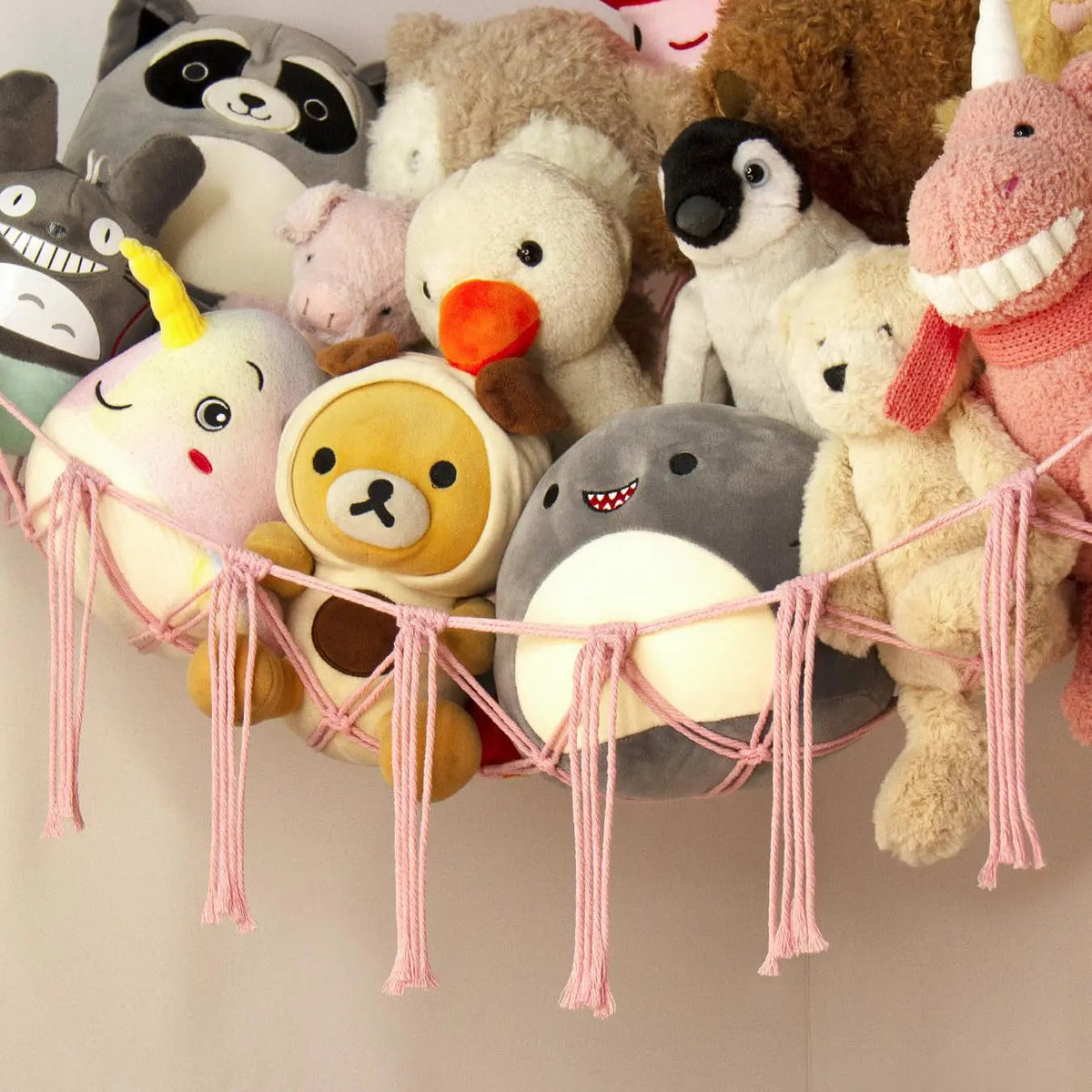 Rope hammock holding stuffed animals