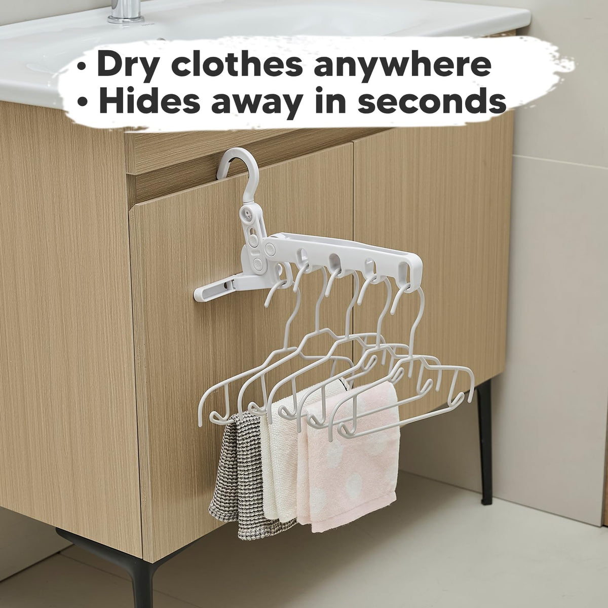 Folding drying rack in use with clothes