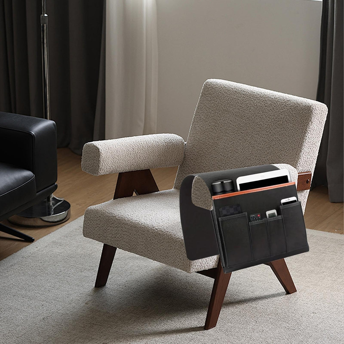 Armrest organiser holding remotes and a tablet