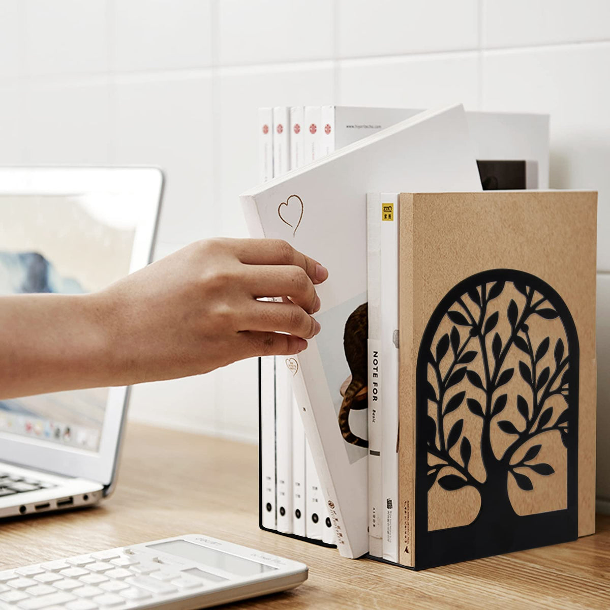 Iron bookend with tree cut-out detail