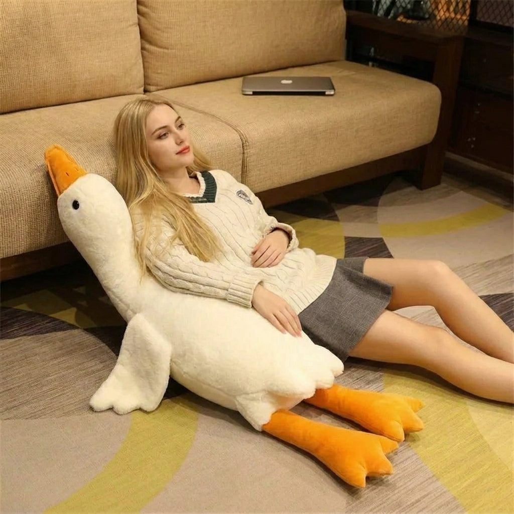 Child hugging goose plush