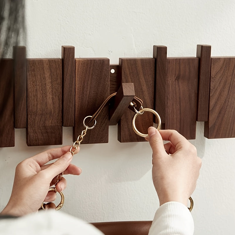 Foldable wooden hooks holding coats and bags