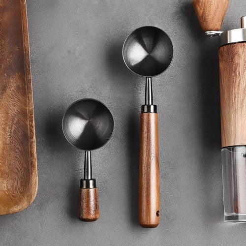 Measuring coffee beans with wooden scoop