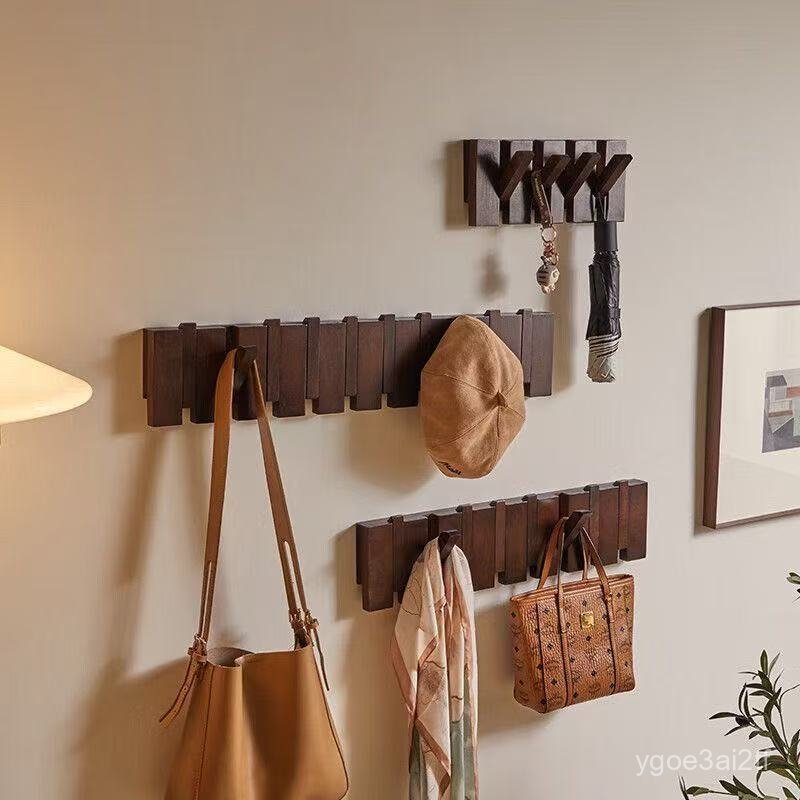 Wooden piano key hook rack on a wall