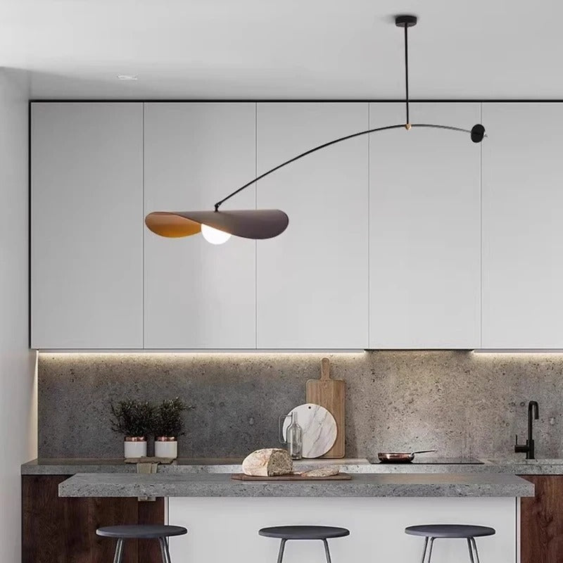 Matte black long arm ceiling pendant over a kitchen island