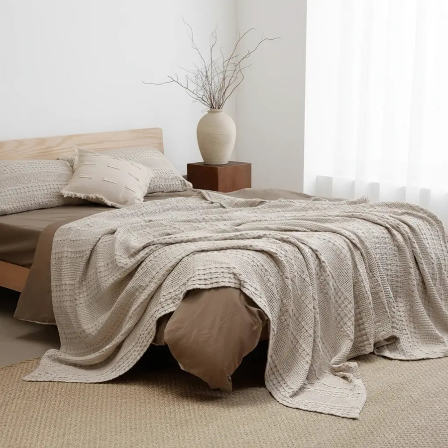 Cotton waffle weave blanket on a bed