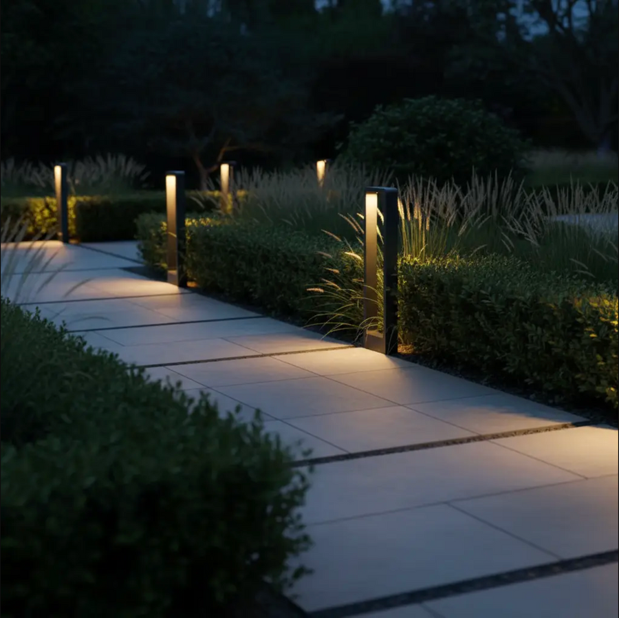 LED garden bollard lights switched on along a path