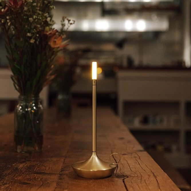 Gold candlestick lamp lit