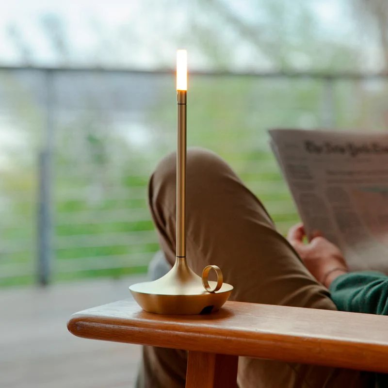 Rechargeable LED candlestick lamp on a table