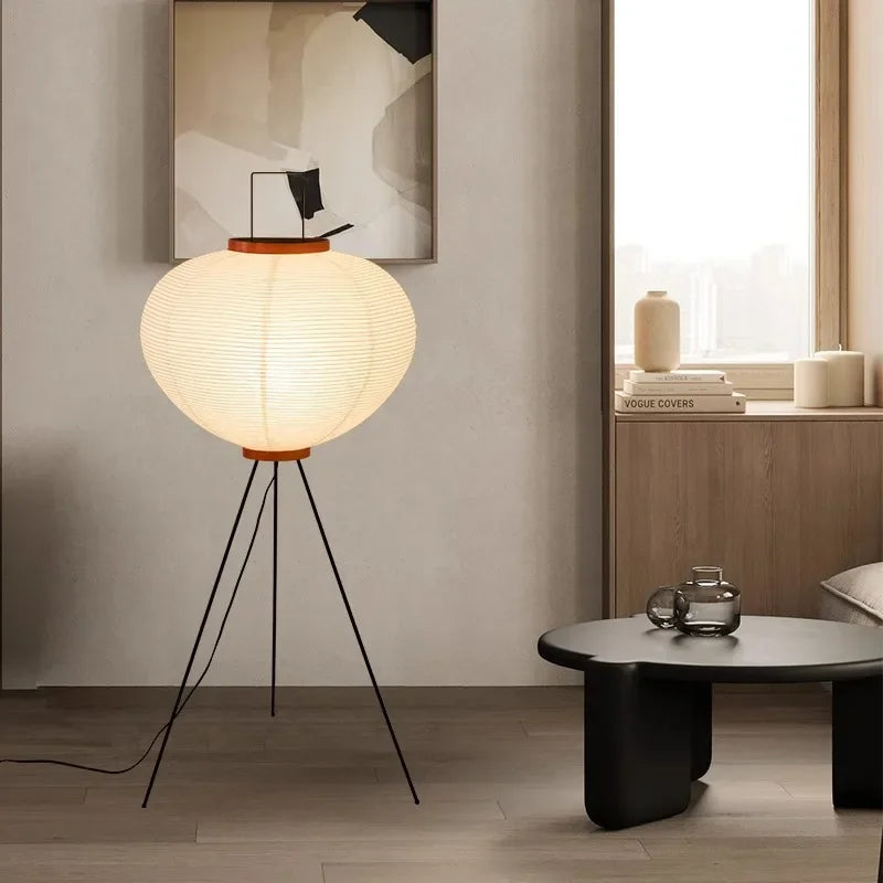 Rice paper floor lamp glowing in a living room